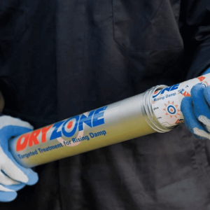 Dryzone Applicator Gun with Dryzone Damp Proofing Cream Being Inserted - Toner Dampproofing Supplies Ltd