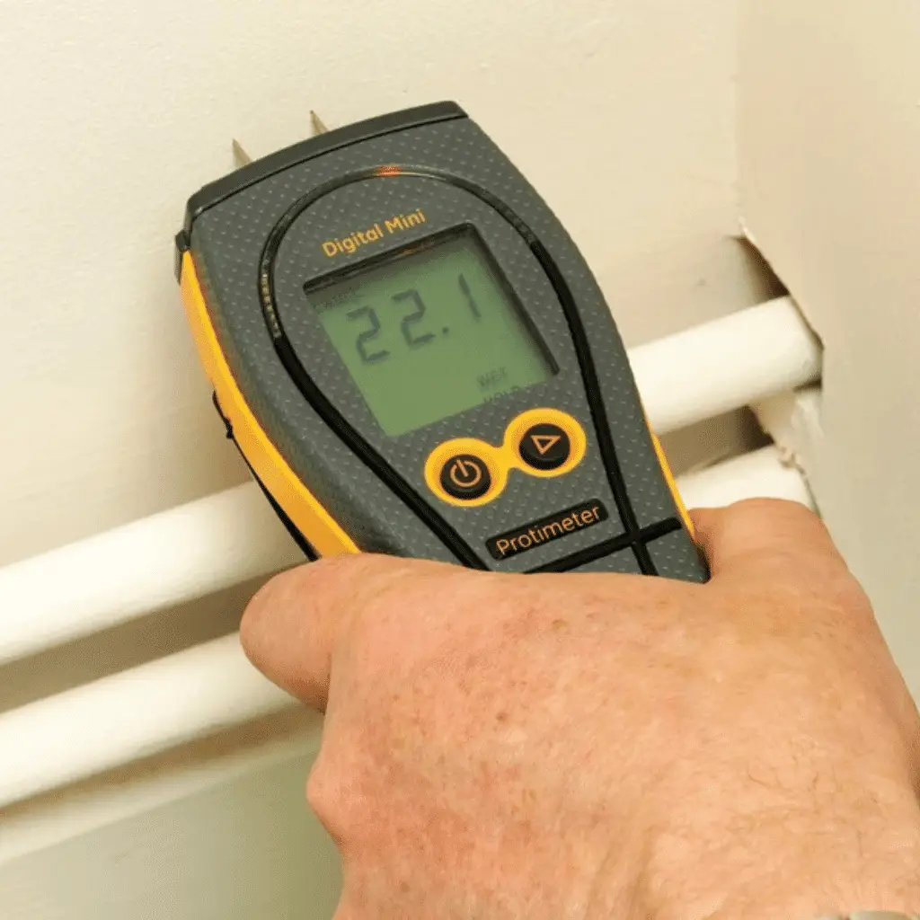 Protimeter Digital Mini Being Used On Masonry Wall Above Pipes