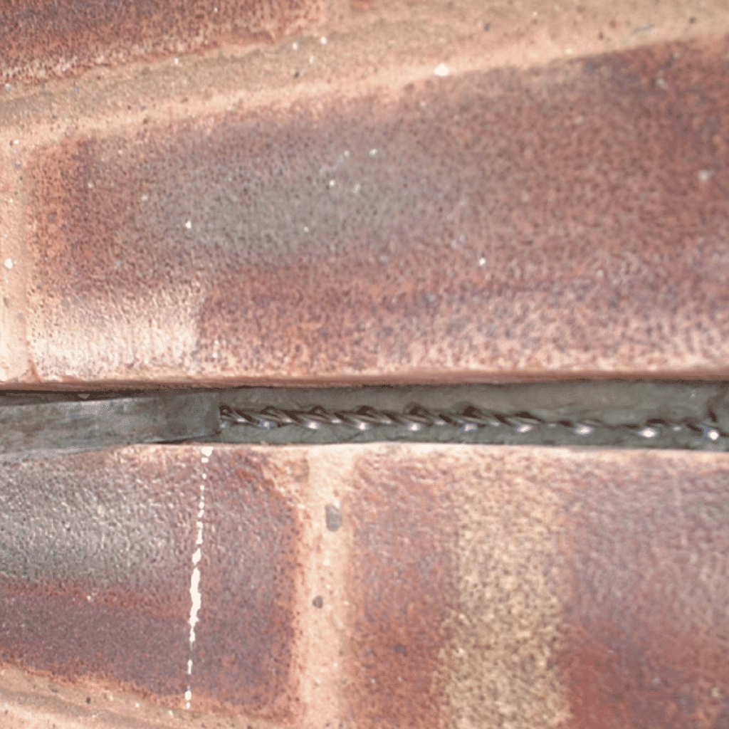 Crack Stitching Being Carried Out To A Property In England